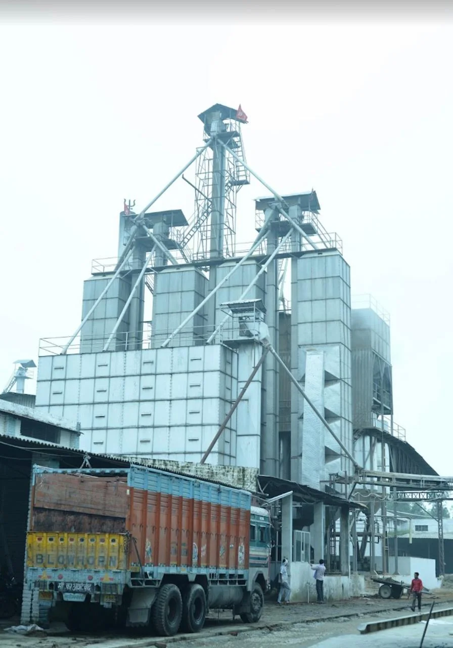 UrbanFresh rice processing plant with grain handling structures and a loading truck in Karnal